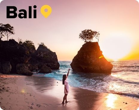 Lady on beach at sunset in Bali Indonesia