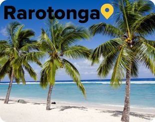 Palm trees on whote sand beach with turquise ocean waters in Rarotonga Cook Islands 