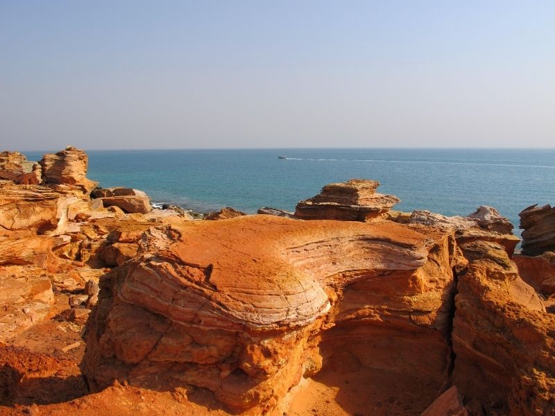 Red rocks next to the ocean