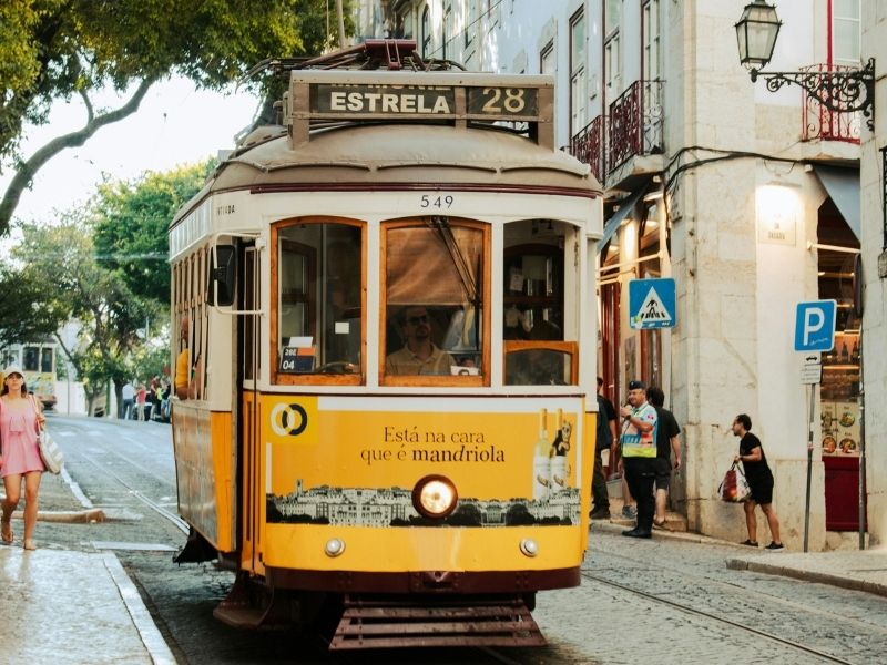 Yellow tram in narrow historical town