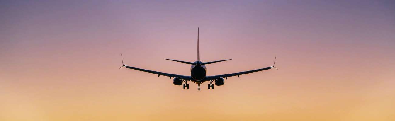 plane taking off at sunset