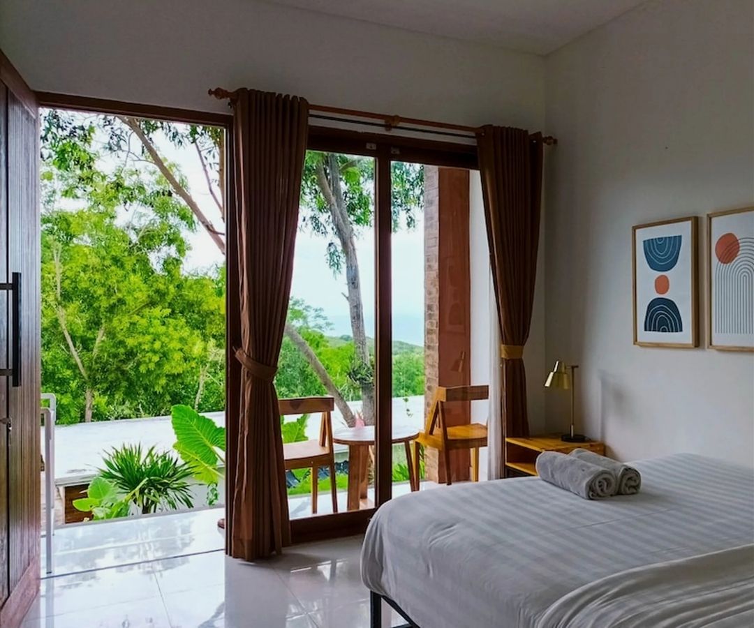 Hotel  room with view over ocean and trees