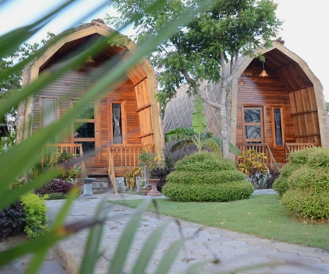 Wooden huts surrounded by plants