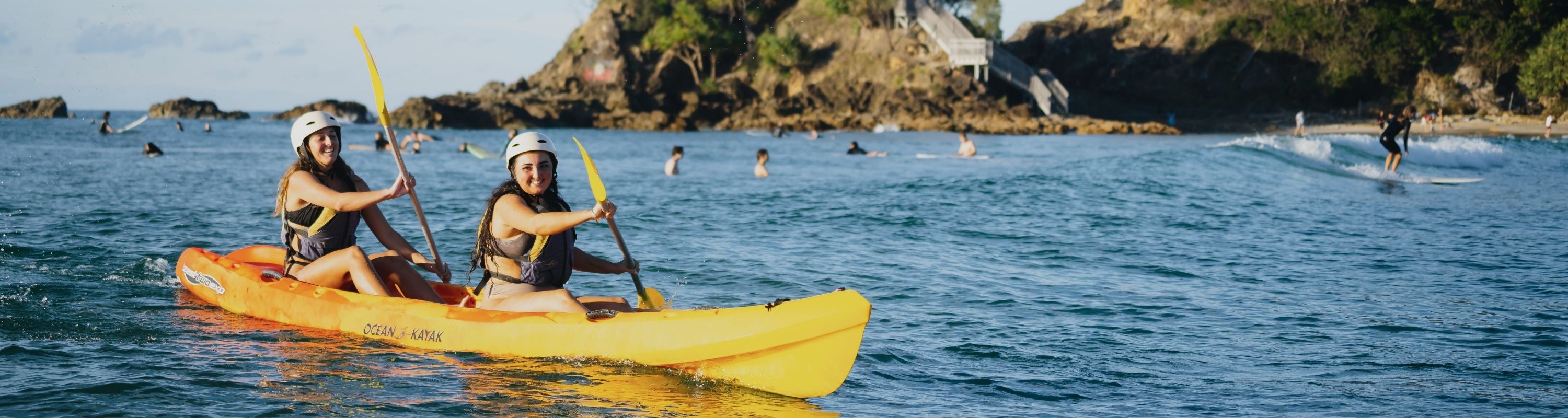 Two happy girls on their kayakas