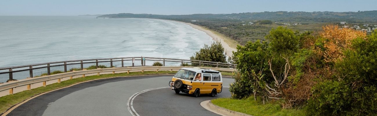 Camper driving a coastal road