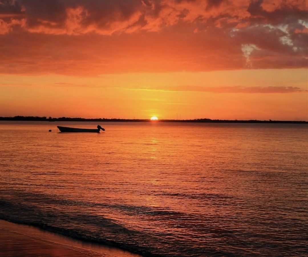 Sun setting into red ocean