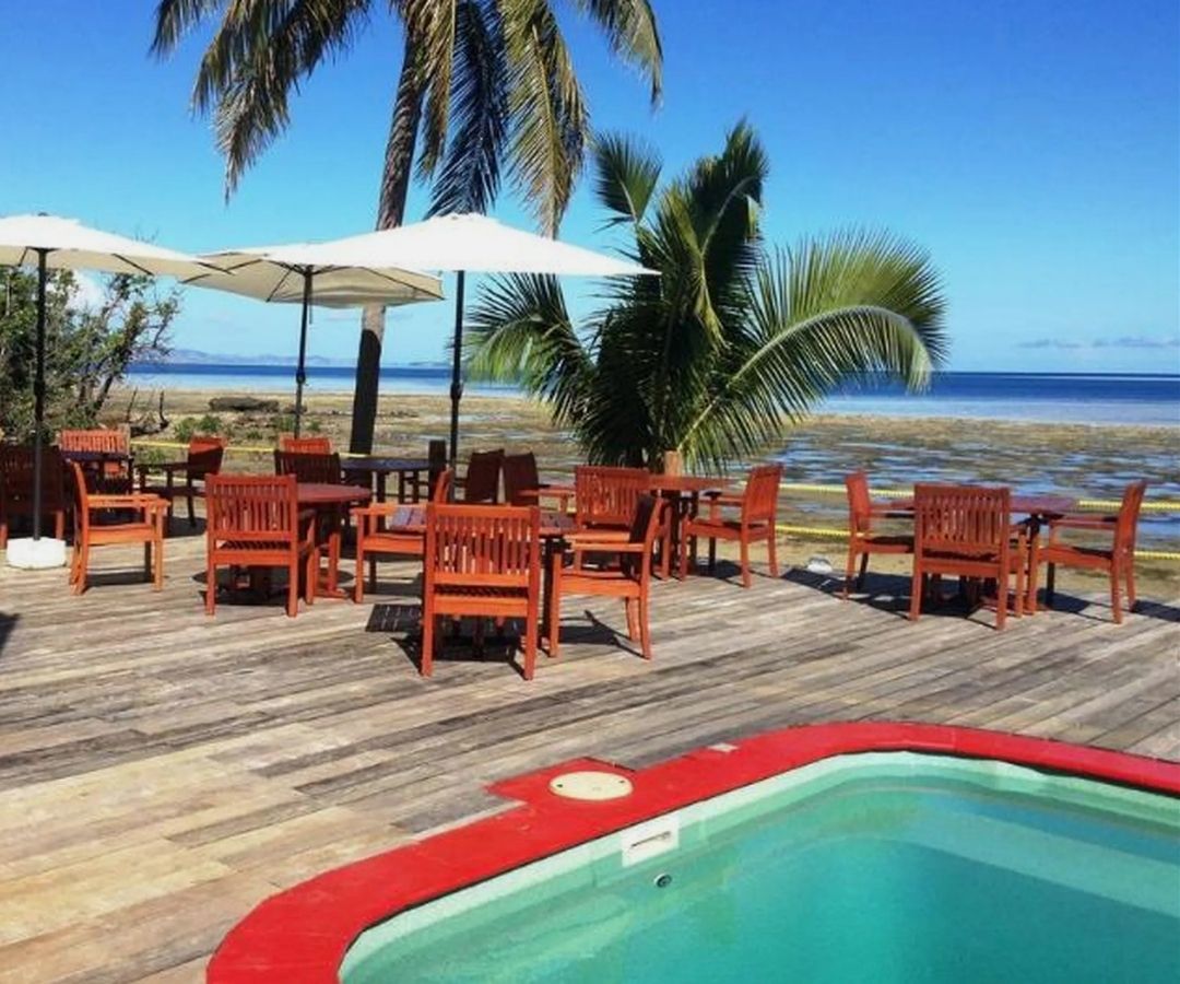 Pool by the ocean with palm trees