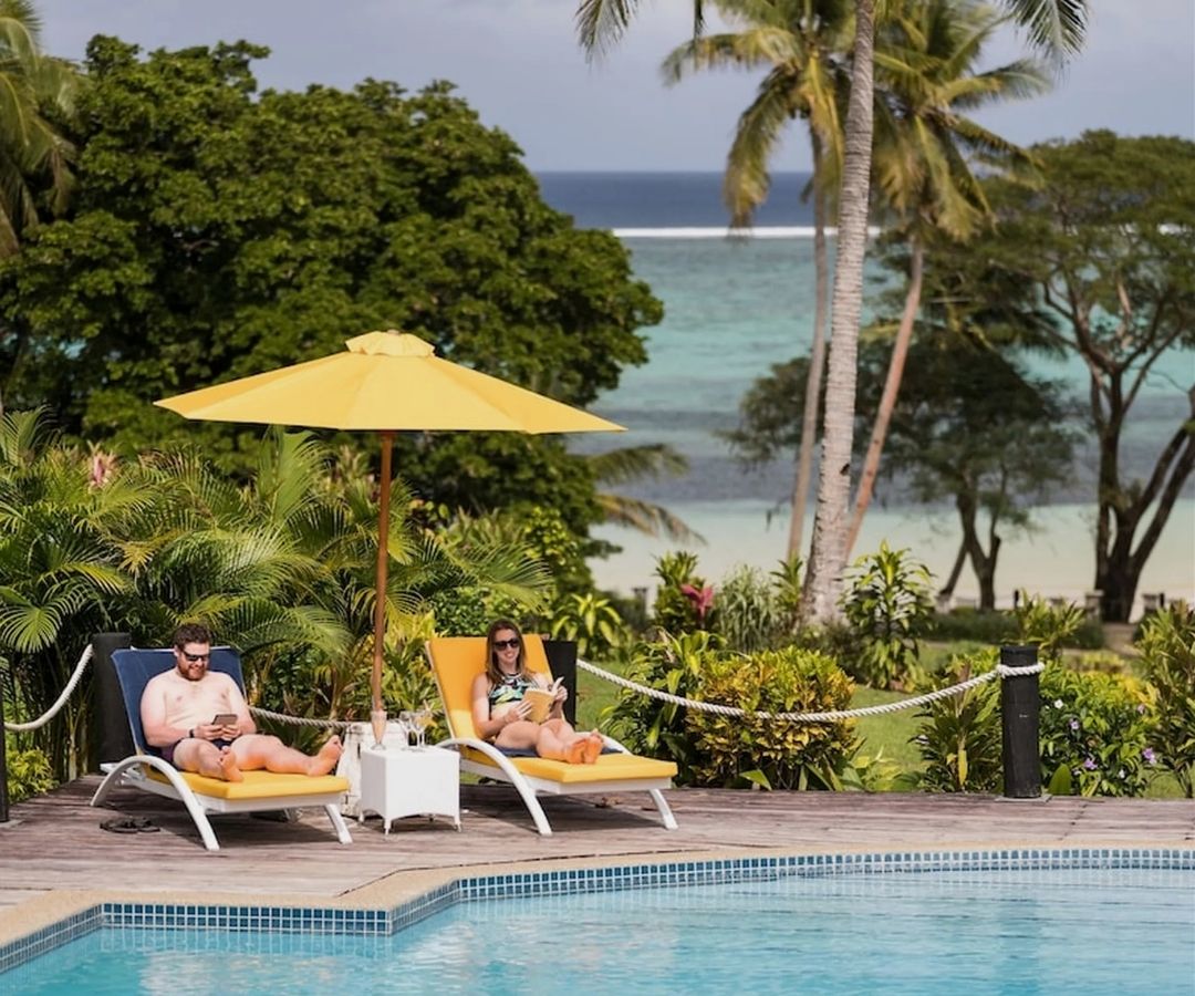 Couple reading by the pool