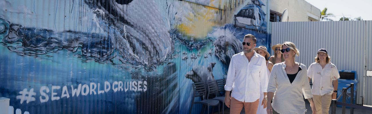 People in front of painted wall