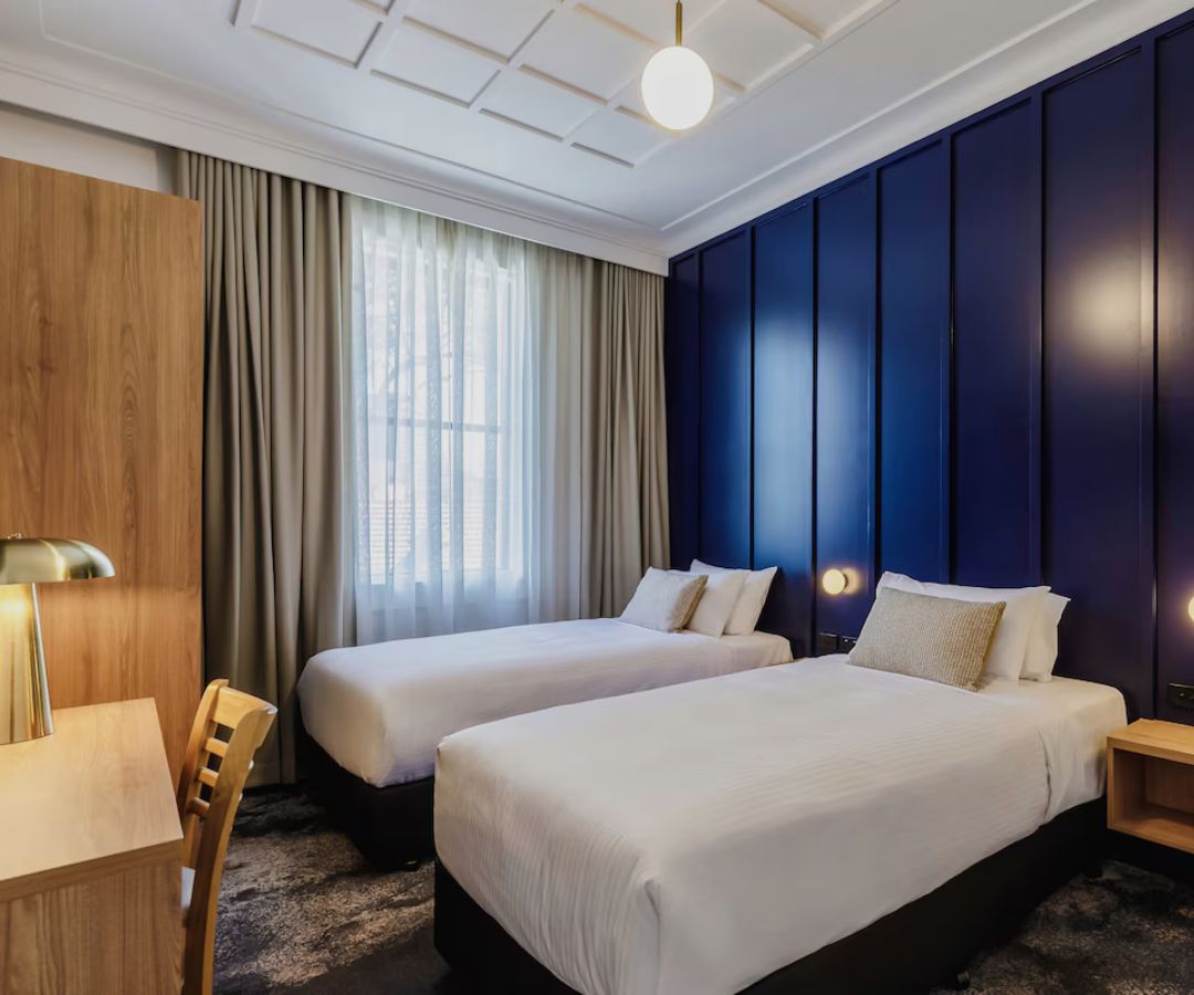 Modern hotel room with blue feature wall