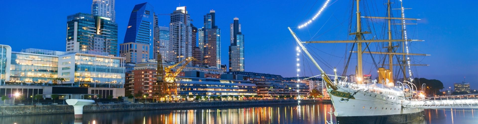 Boat on the water with skyscrapers in background
