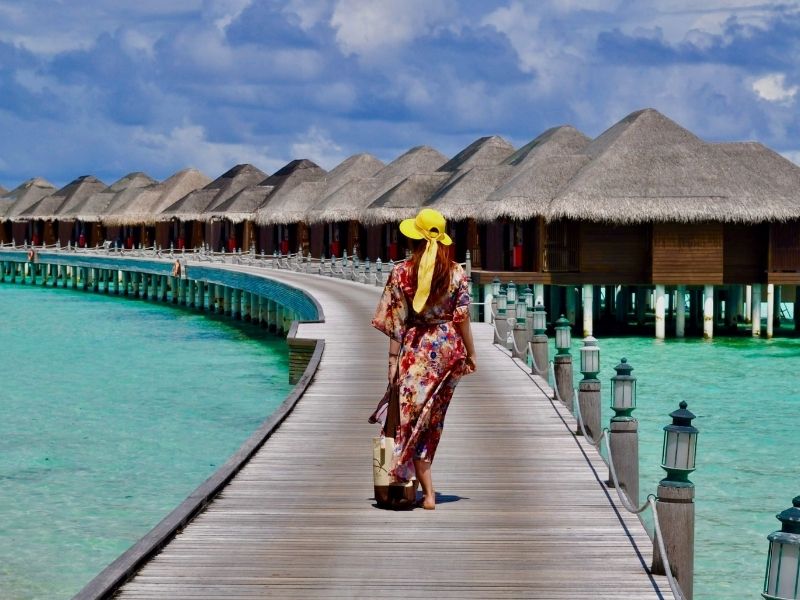 lady walking to overwater bungalows