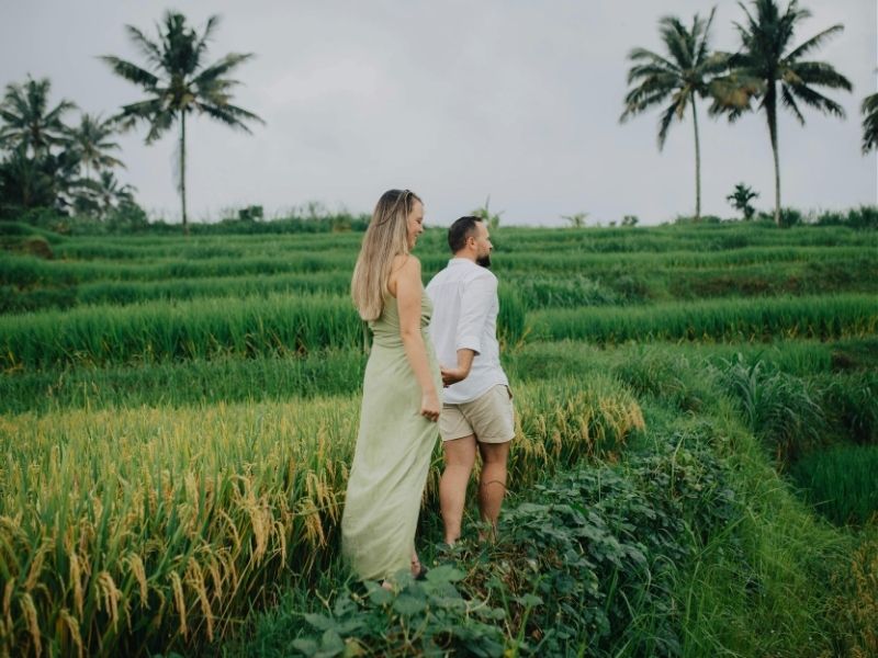 couple walking in rice rerrace bali