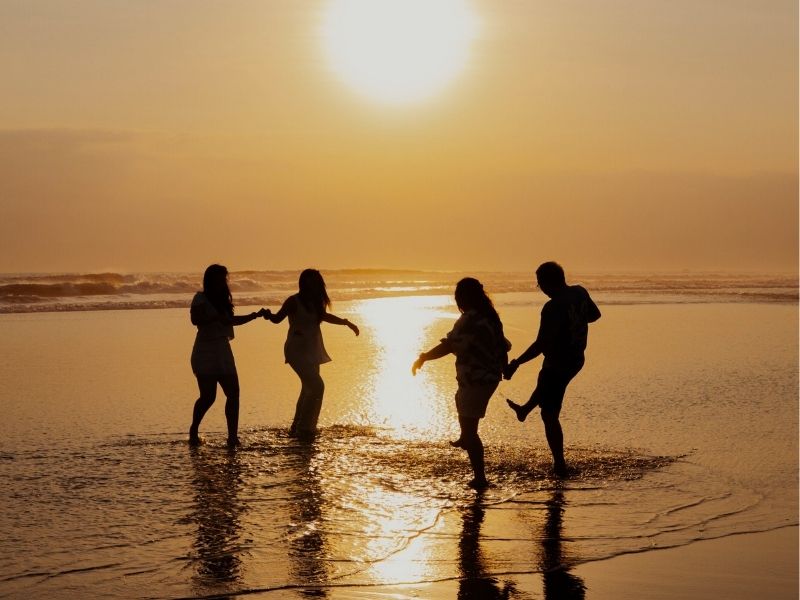 four friends on a beach