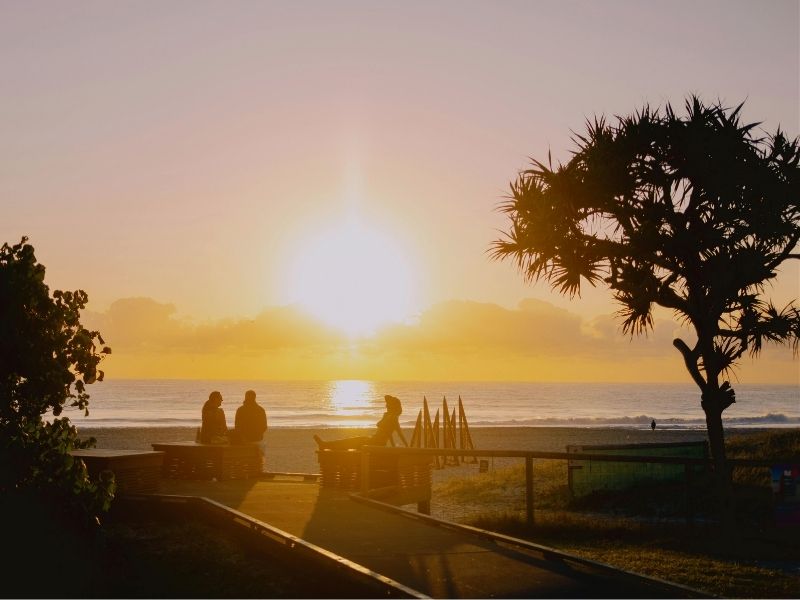 friends at ocean at sunset