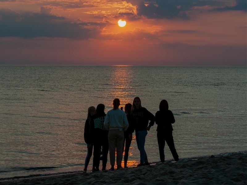 friends on a beach at sunset