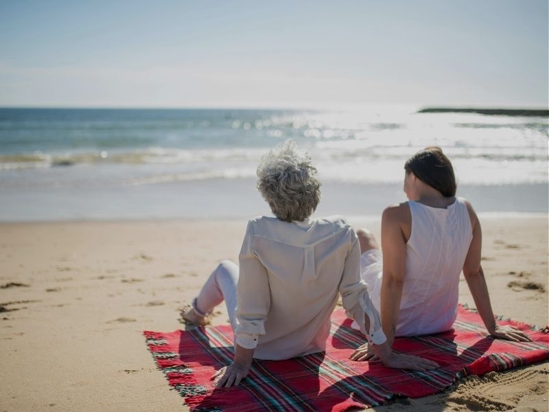 mother and daughter relaxing on beach