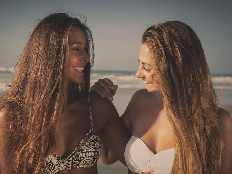 friends smiling on beach