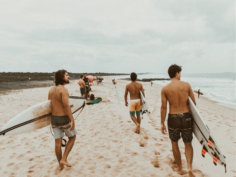 surfers on beach