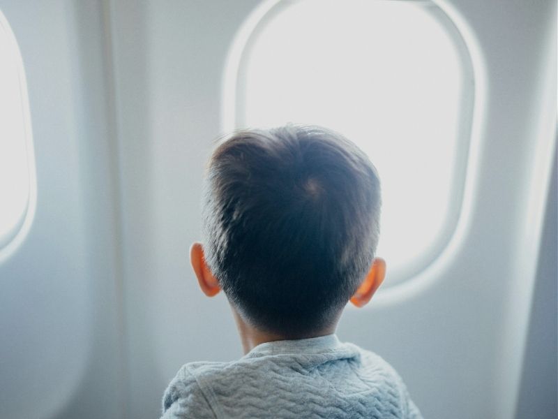 child looking out plane window