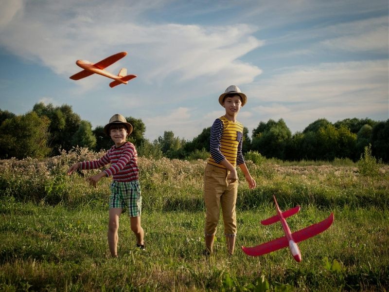 young children playing with planes