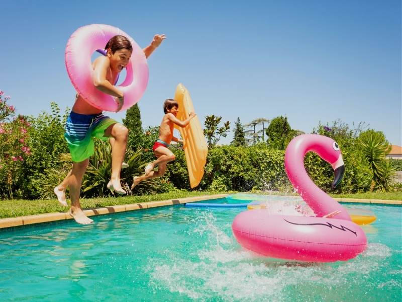 kids jumping into pool