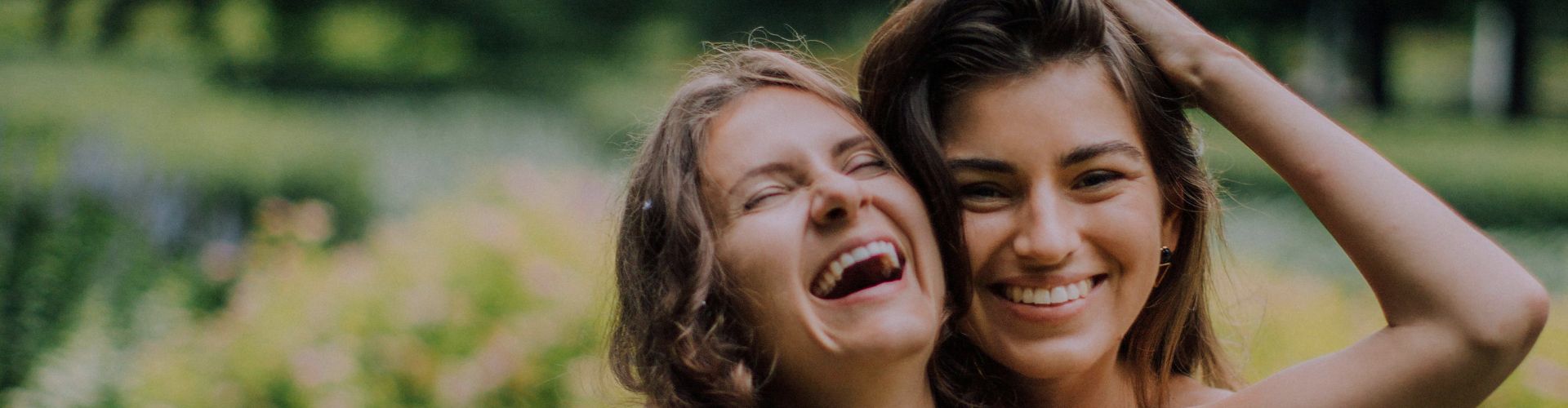 smiling friends in embrace